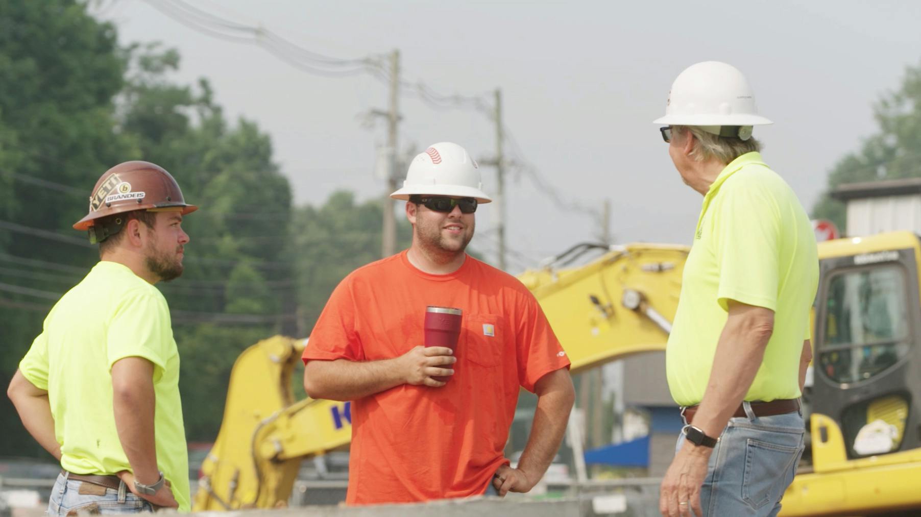 Three workers on break at a job site