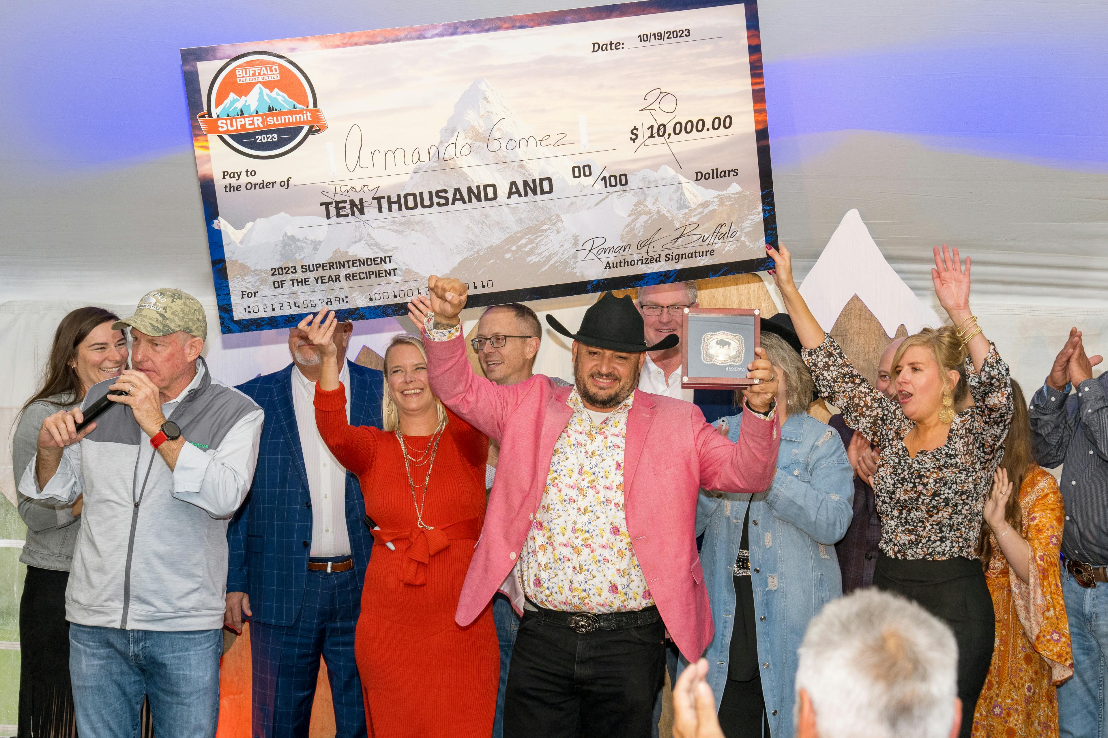 A trophy and oversized check prize being awarded at the 2023 Super Summit