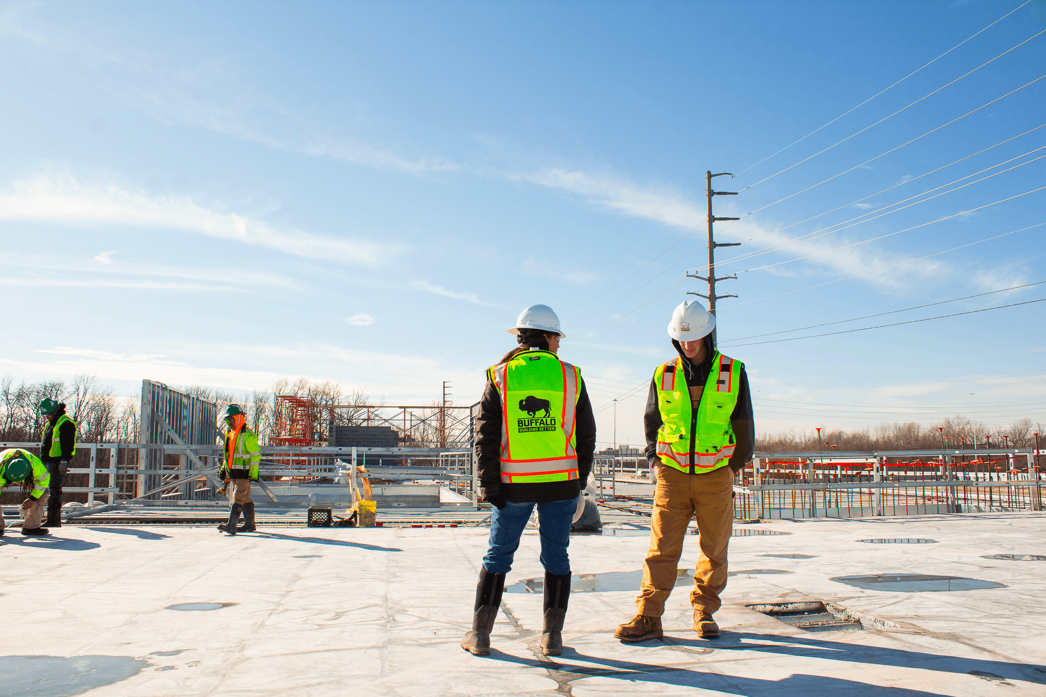 Workers posing on top of a building under construction